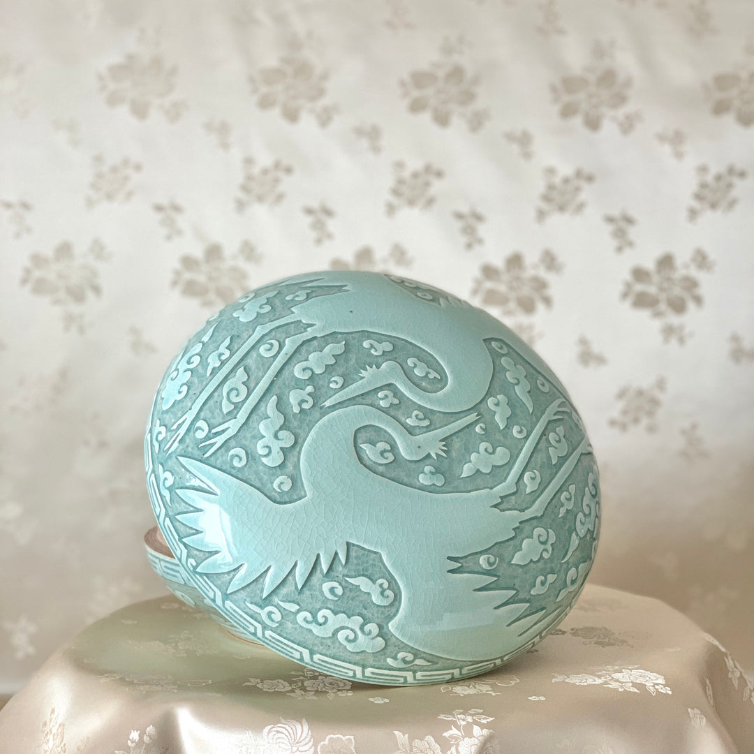 Large handmade celadon box with an intricate crane and cloud pattern, exemplifying traditional Korean artistry and elegance.