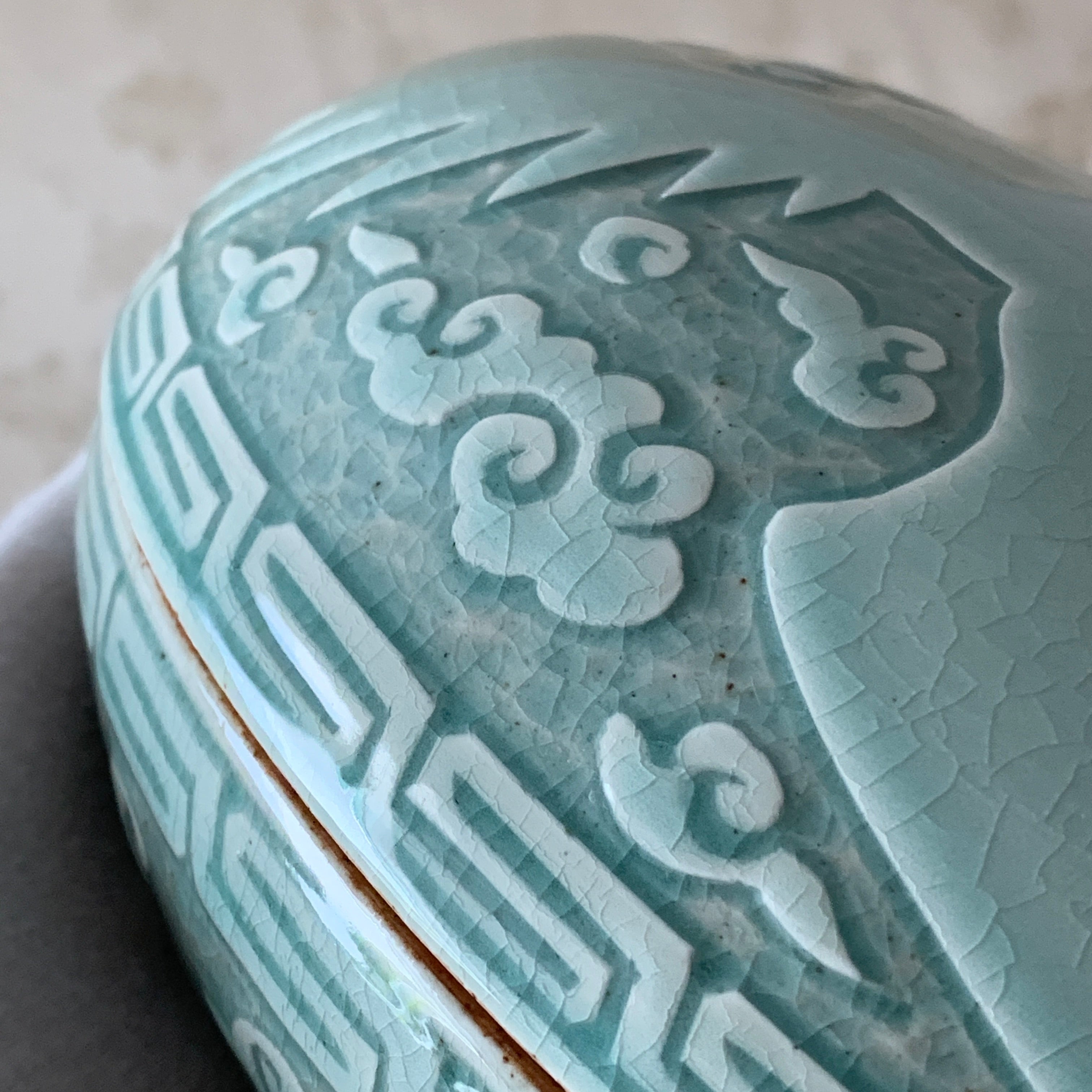 Large handmade celadon box with an intricate crane and cloud pattern, exemplifying traditional Korean artistry and elegance.