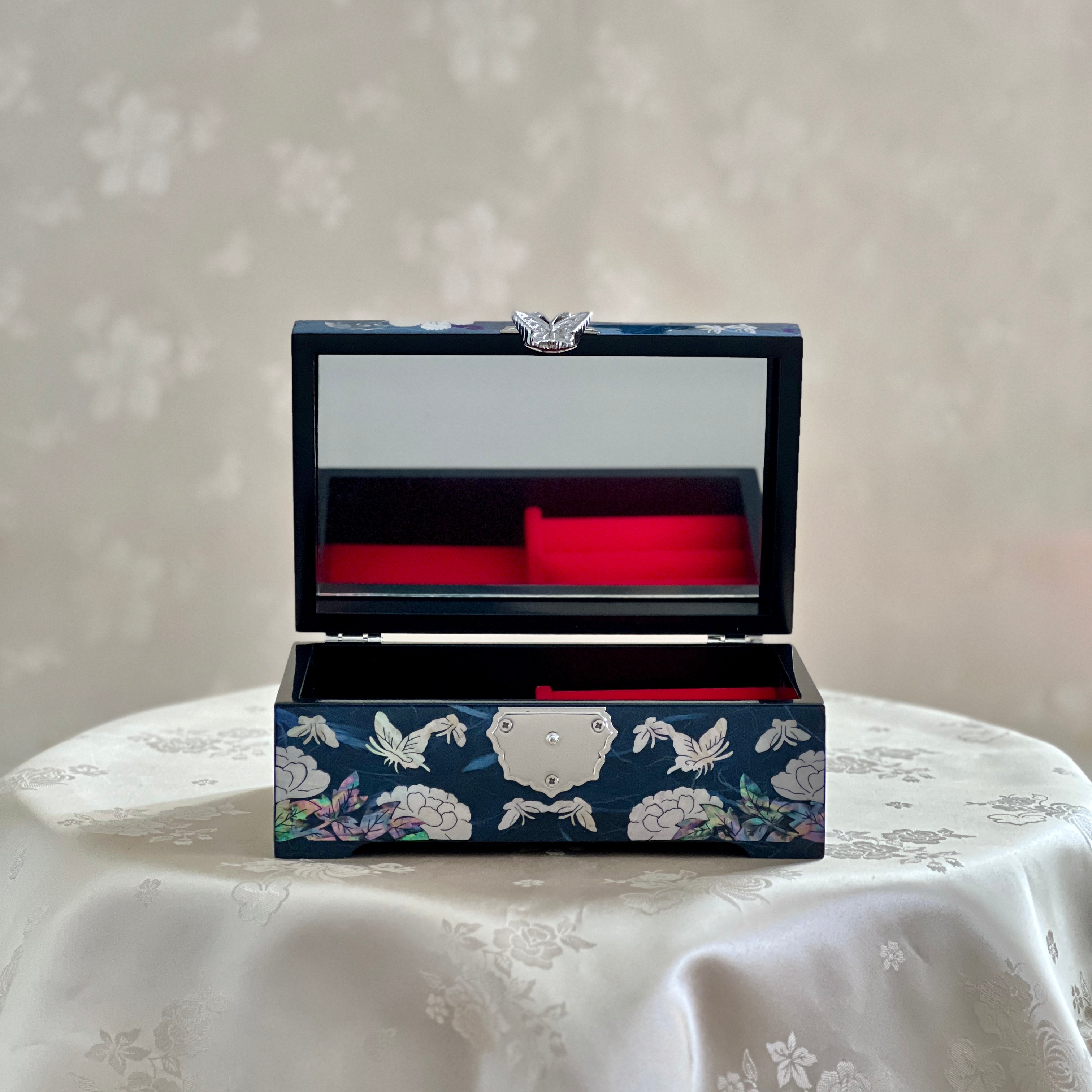 Open view of Handmade Korean mother of pearl jewelry box with crane and pine pattern on navy paper-layered design, perfect for storing valuable jewelry.