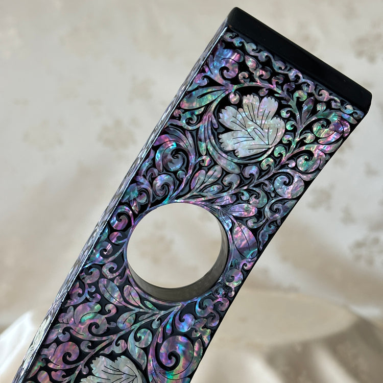 Close-up of the plum blossom pattern on the handmade Korean mother of pearl wine holder.