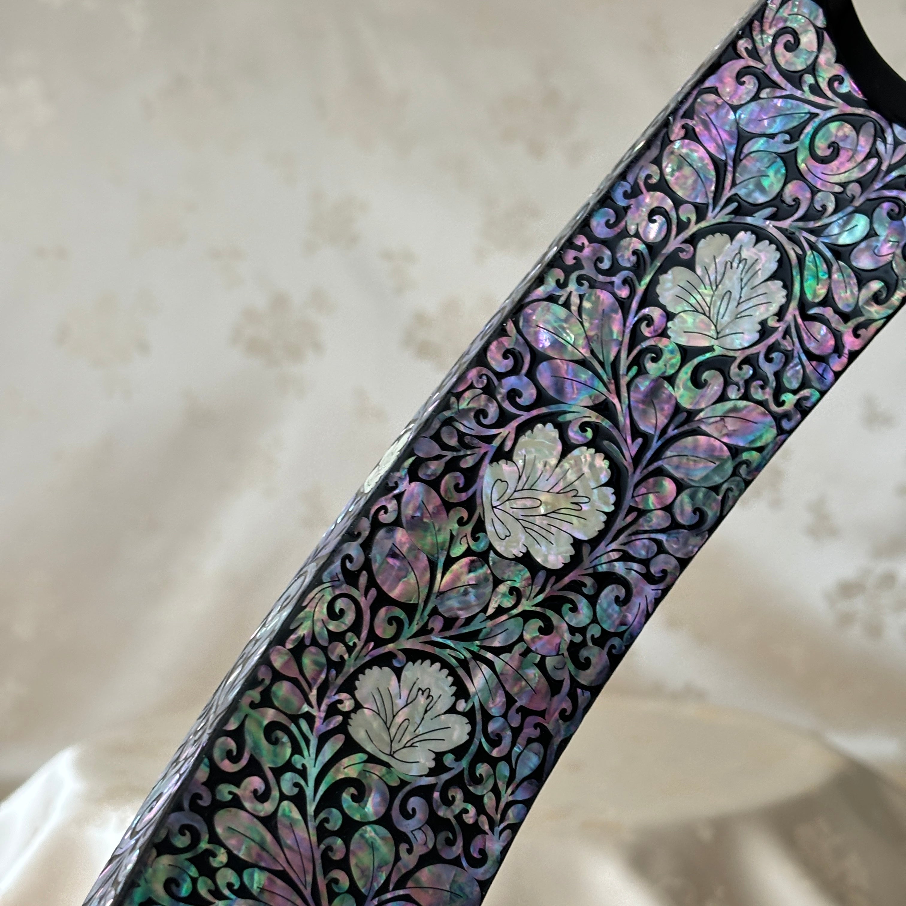 Close-up of the plum blossom pattern on the handmade Korean mother of pearl wine holder.