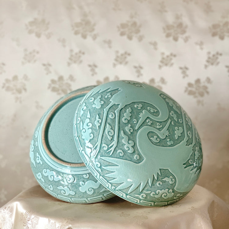 Large handmade celadon box with an intricate crane and cloud pattern, exemplifying traditional Korean artistry and elegance.