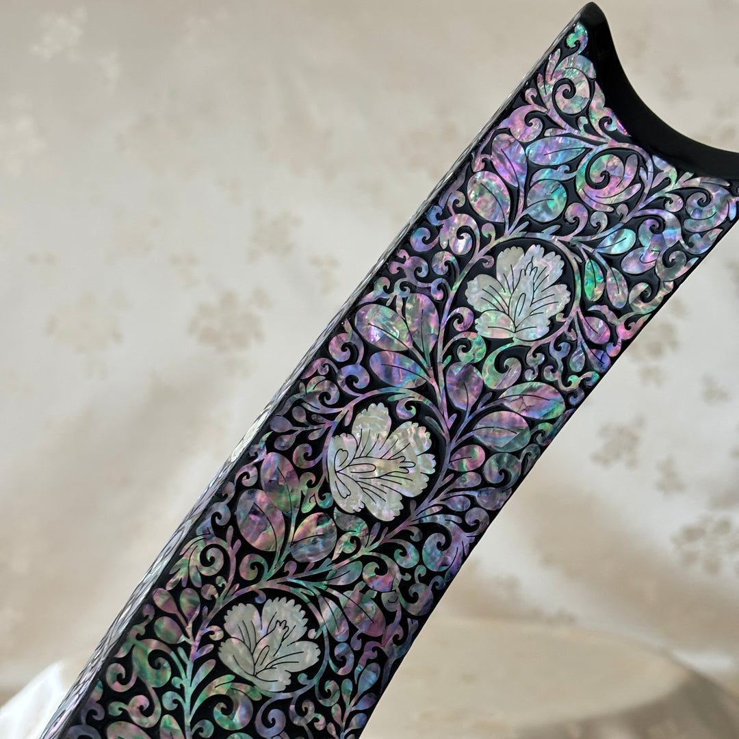 Close-up of the plum blossom pattern on the handmade Korean mother of pearl wine holder.