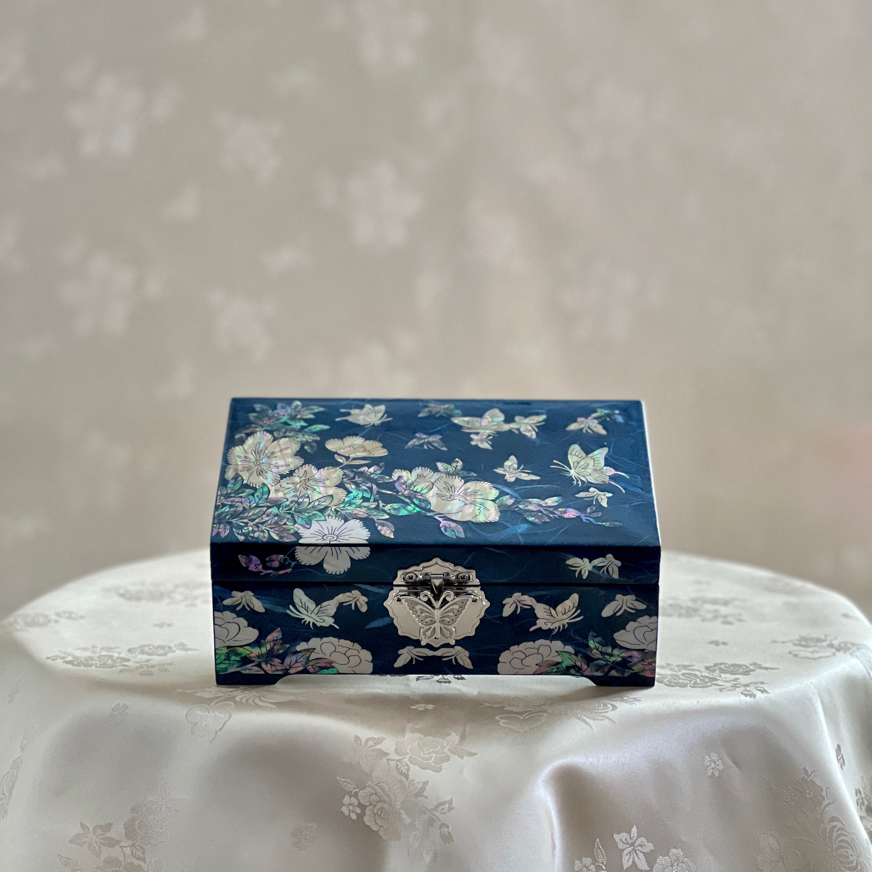 Upper view of Handmade Korean mother of pearl jewelry box with crane and pine pattern on navy paper-layered design, perfect for storing valuable jewelry.