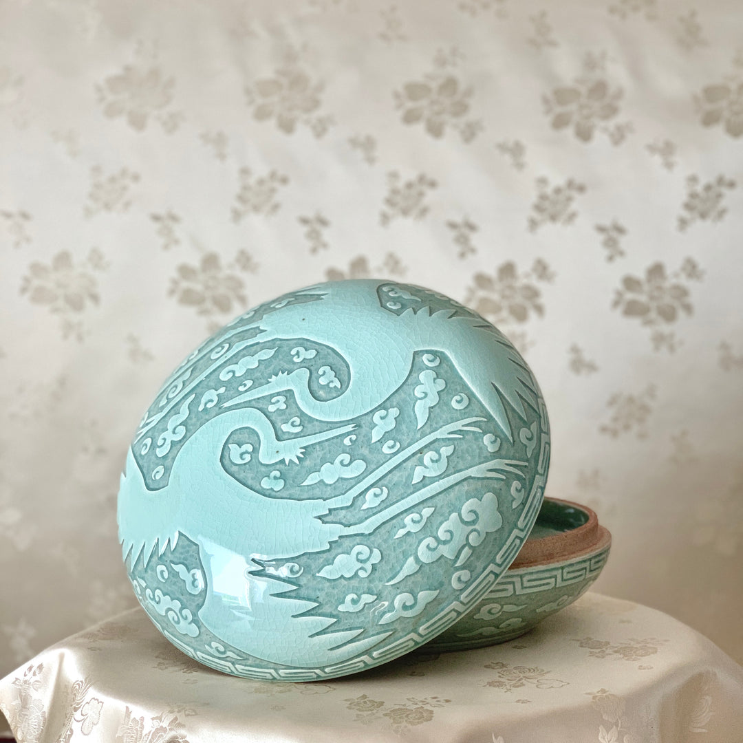 Large handmade celadon box with an intricate crane and cloud pattern, exemplifying traditional Korean artistry and elegance.