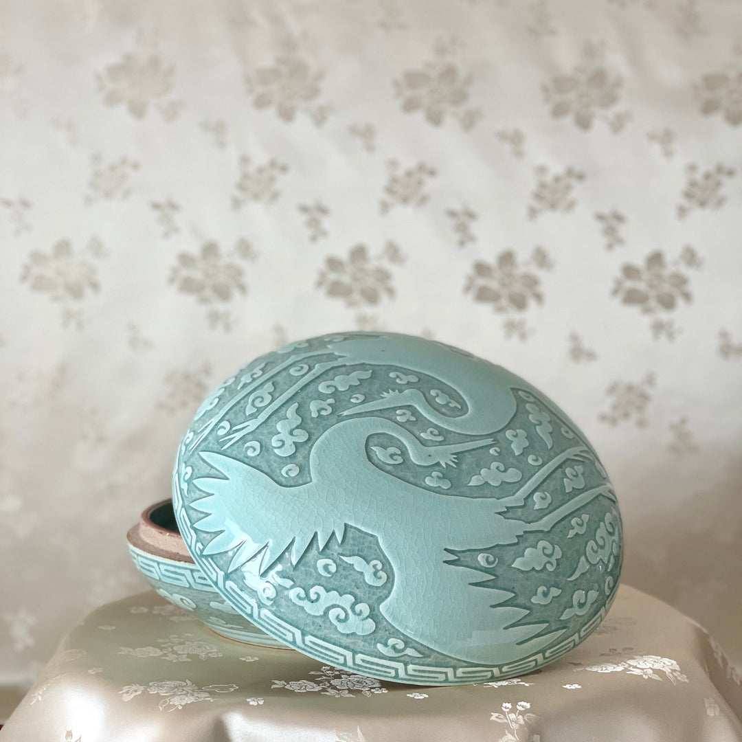 Large handmade celadon box with an intricate crane and cloud pattern, exemplifying traditional Korean artistry and elegance.