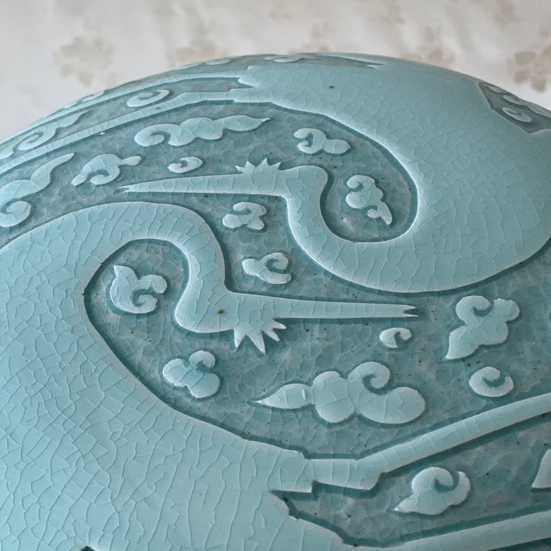 Large handmade celadon box with an intricate crane and cloud pattern, exemplifying traditional Korean artistry and elegance.