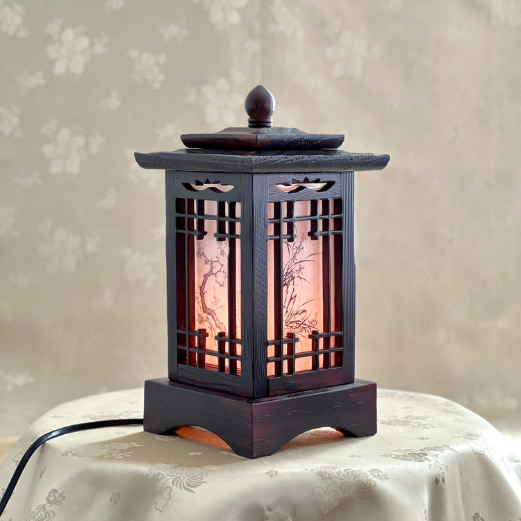 Front view of a handmade Korean traditional wooden table lamp with a square pagoda-shaped roof and Sagunja patterns.