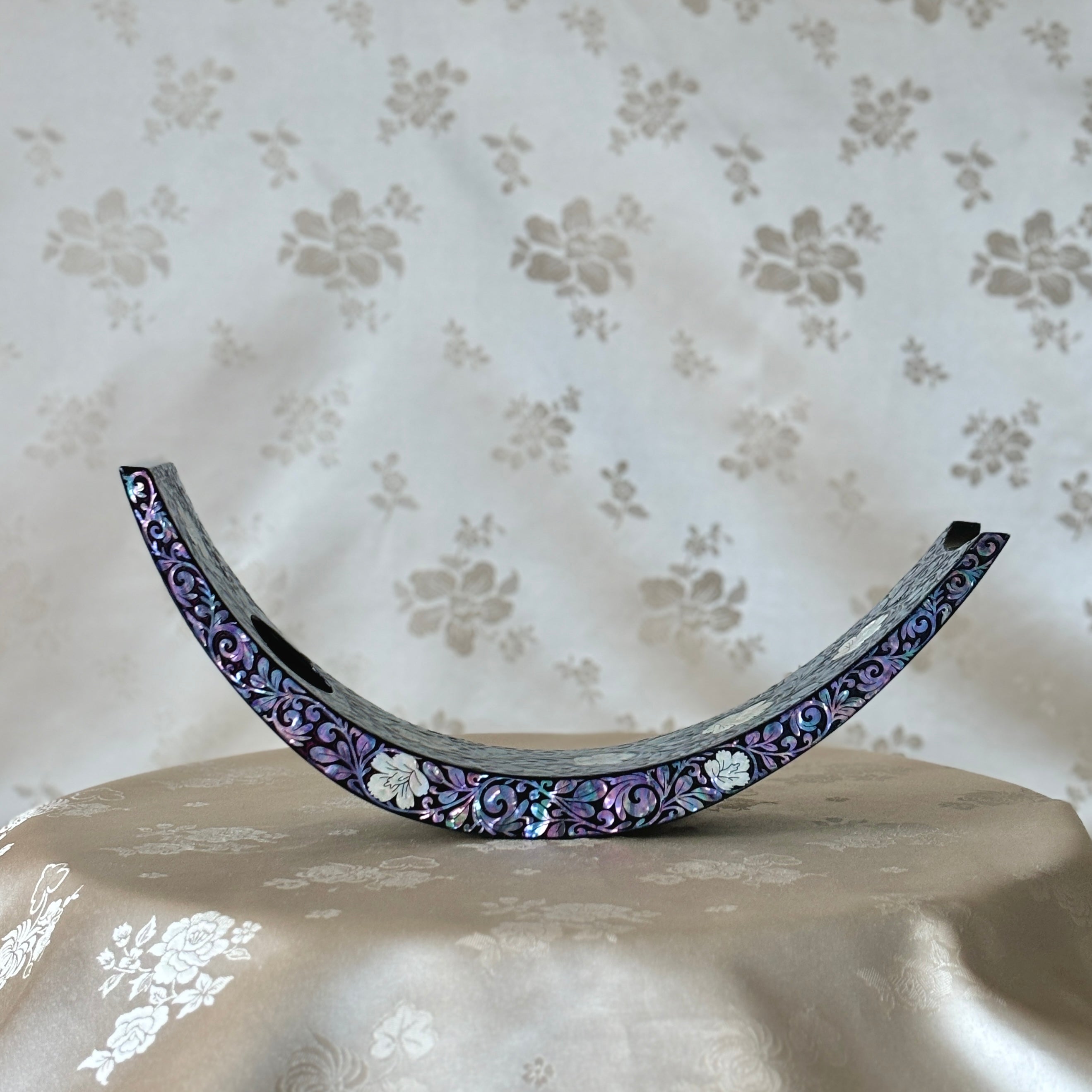 Front view of a Korean traditional handmade mother of pearl wine holder with intricate plum blossom design.