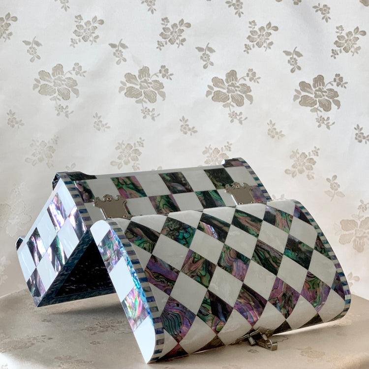 Upper view of a handmade Korean mother of pearl and cheongpa wooden jewelry box showcasing the reflective checkered pattern.