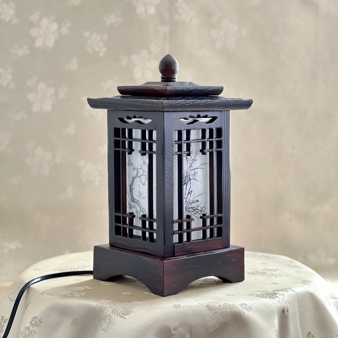 Front view of a handmade Korean traditional wooden table lamp with a square pagoda-shaped roof and Sagunja patterns.