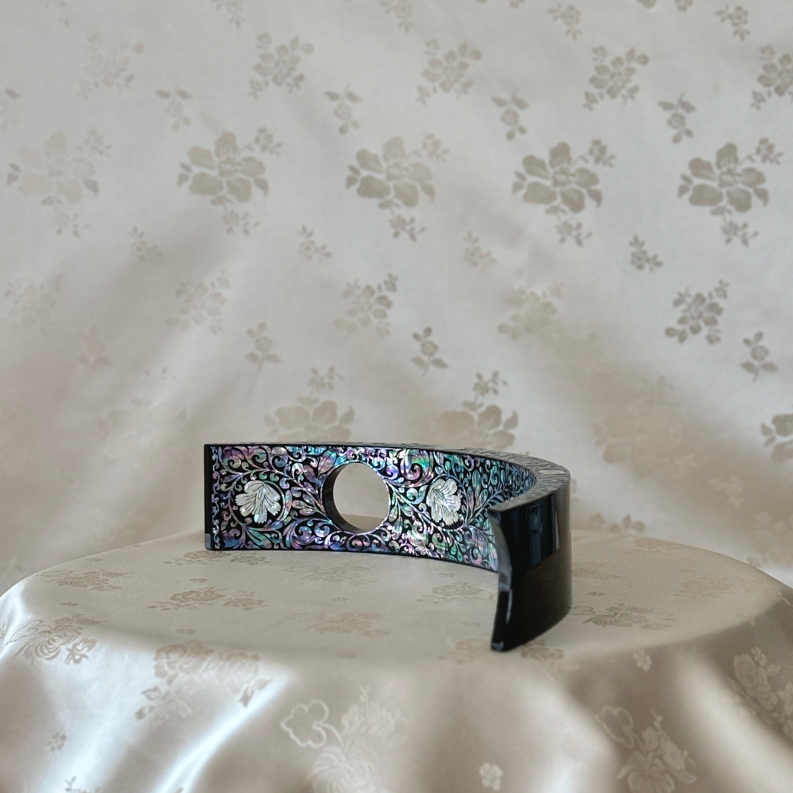 Upper view of a luxurious Korean traditional handmade mother of pearl wine holder with a plum blossom pattern.