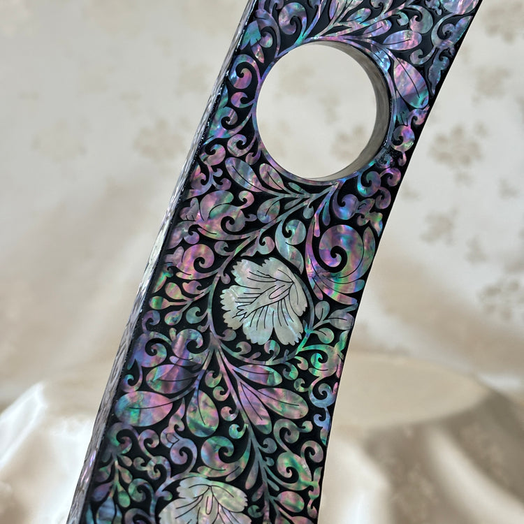 Close-up of the plum blossom pattern on the handmade Korean mother of pearl wine holder.