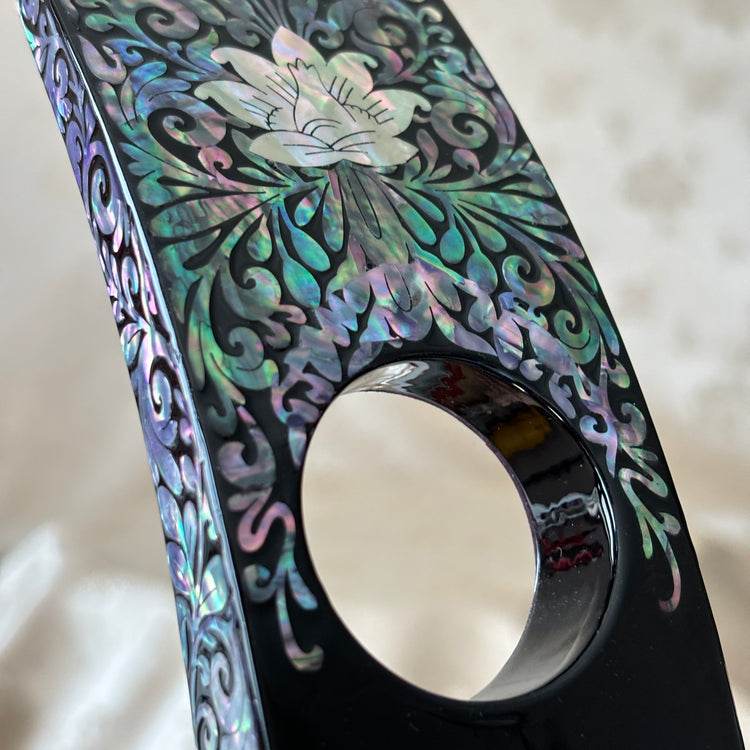 Close-up of the plum blossom pattern on the handmade Korean mother of pearl wine holder.