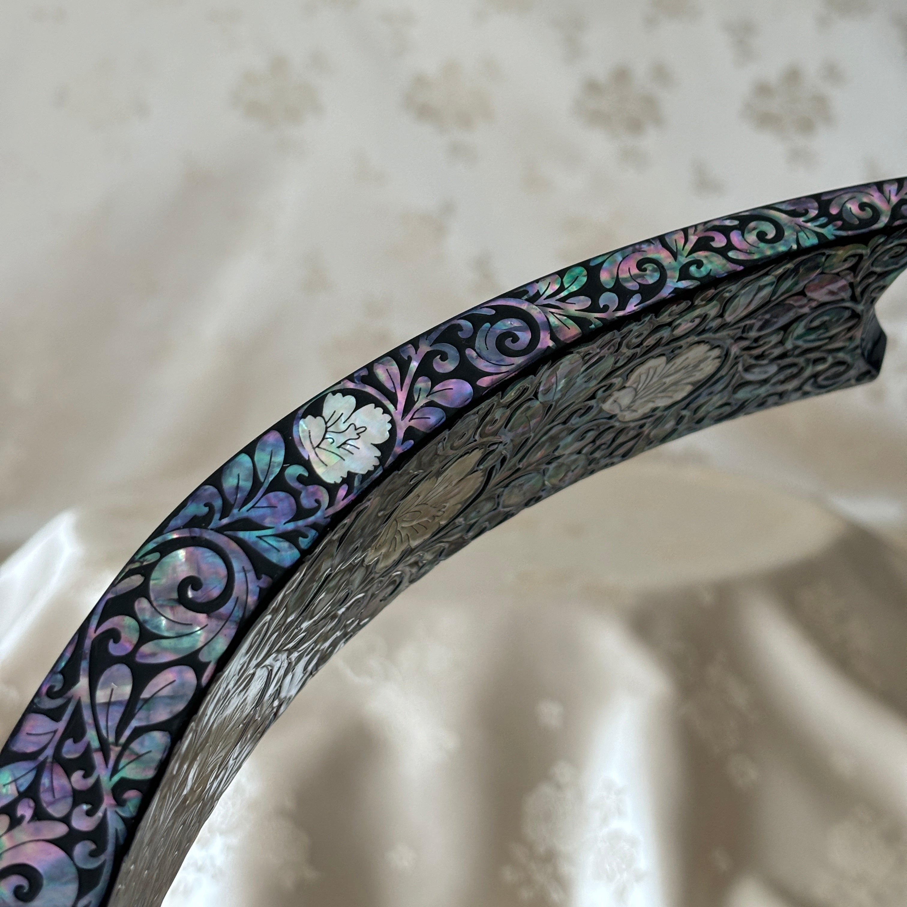 Close-up of the plum blossom pattern on the handmade Korean mother of pearl wine holder.