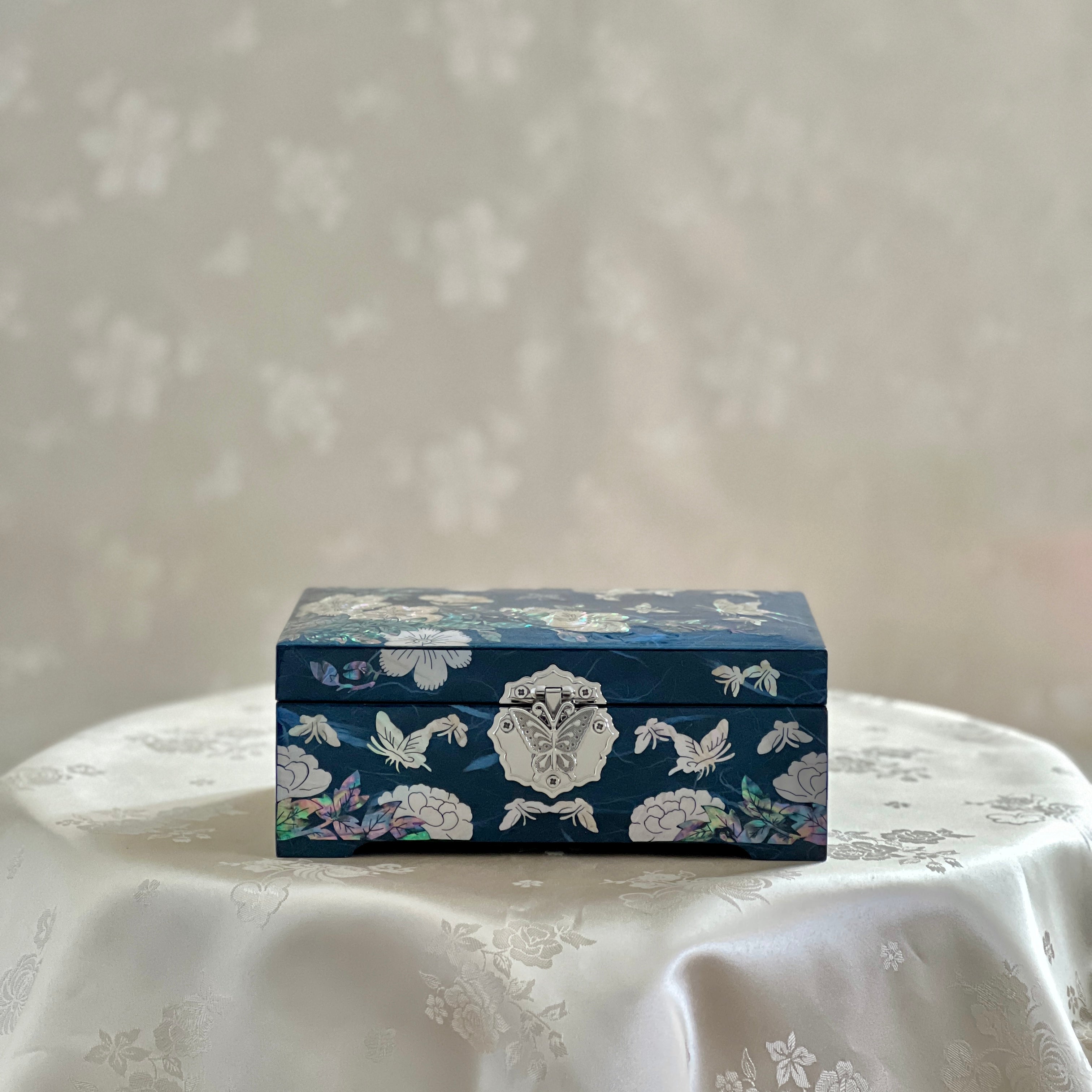 Front view of Handmade Korean mother of pearl jewelry box with crane and pine pattern on navy paper-layered design, perfect for storing valuable jewelry.