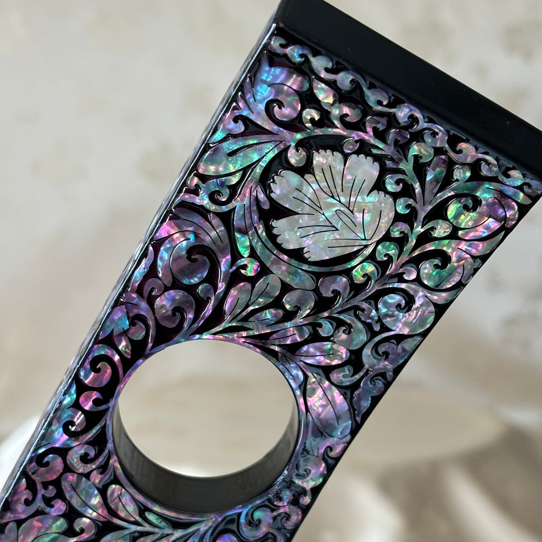 Close-up of the plum blossom pattern on the handmade Korean mother of pearl wine holder.