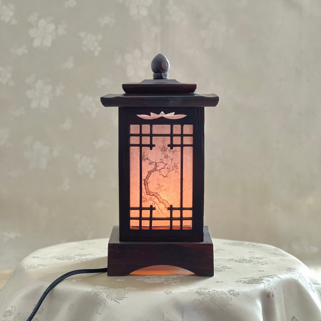 Front view of a handmade Korean traditional wooden table lamp with a square pagoda-shaped roof and Sagunja patterns.