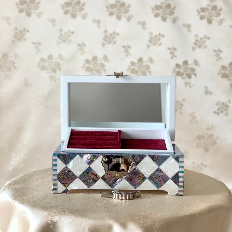 Open view of the handmade Korean mother of pearl and cheongpa wooden jewelry box, revealing the luxurious shell-lined interior and compartments.