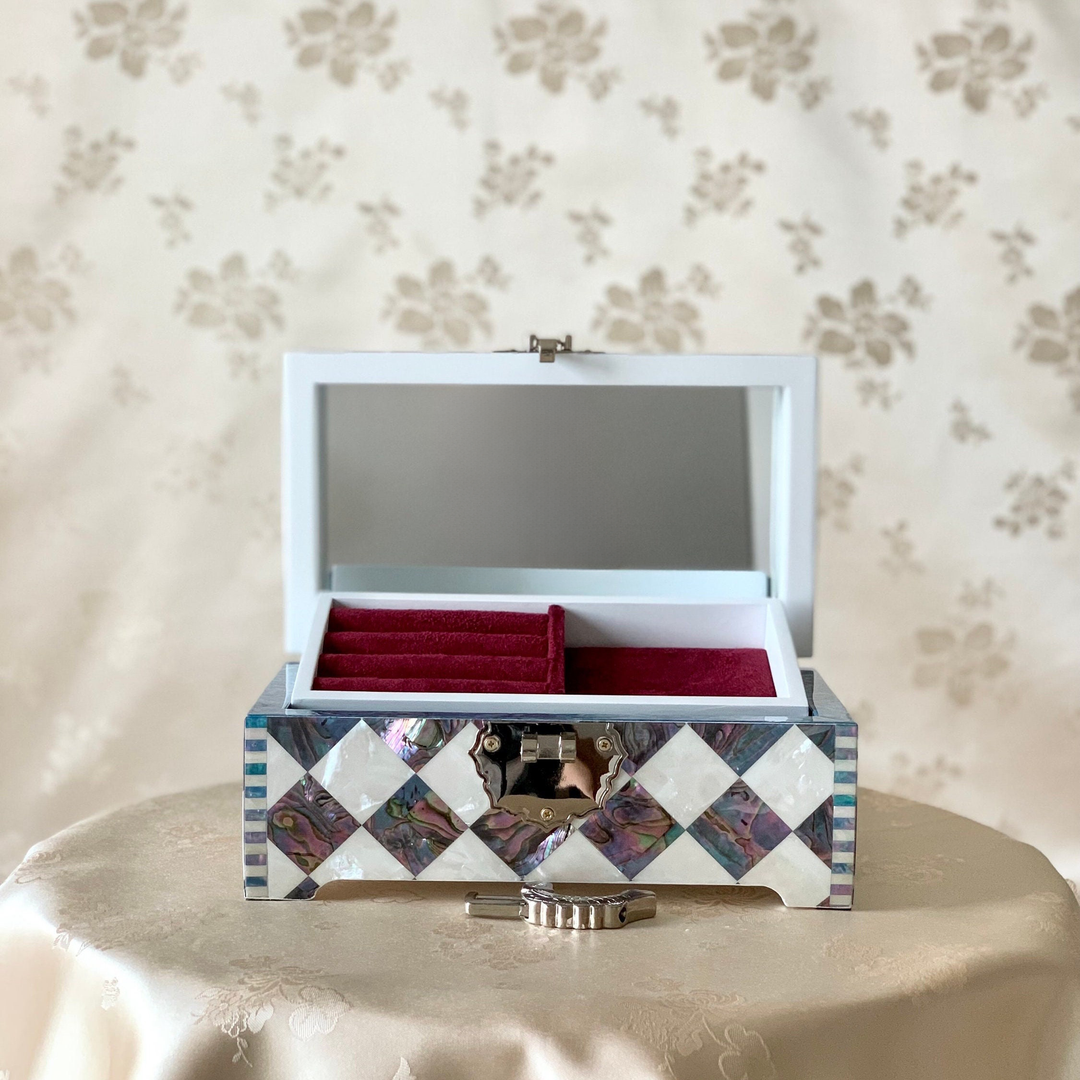 Open view of the handmade Korean mother of pearl and cheongpa wooden jewelry box, revealing the luxurious shell-lined interior and compartments.