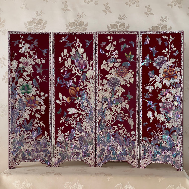 Korean Traditional Handmade Mother of Pearl Black Color Wooden Folding Screen on a table, featuring a pattern of birds, butterflies, and flowers.