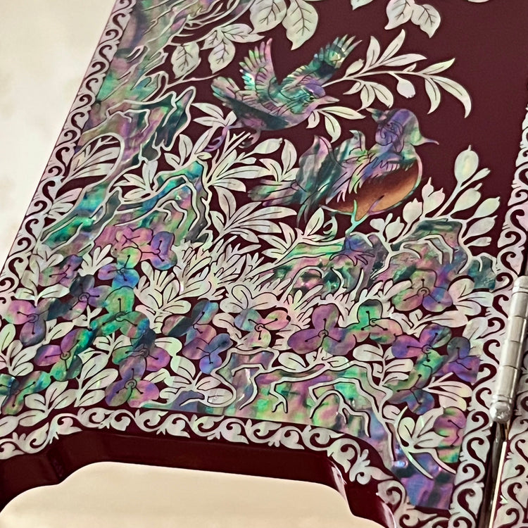 Korean Traditional Handmade Mother of Pearl Black Color Wooden Folding Screen on a table, featuring a pattern of birds, butterflies, and flowers.